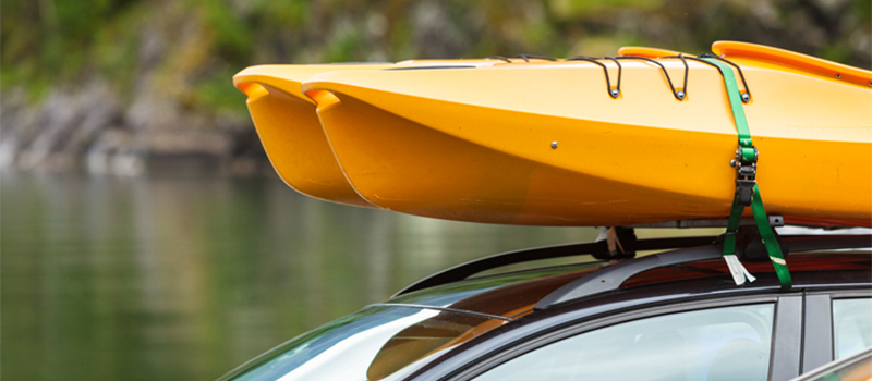 Kayak secured to car roof