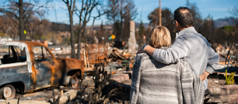 Couple looking at their burned out property