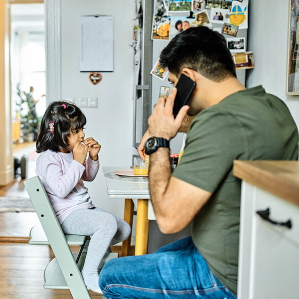 Father and daughter at kitchen table