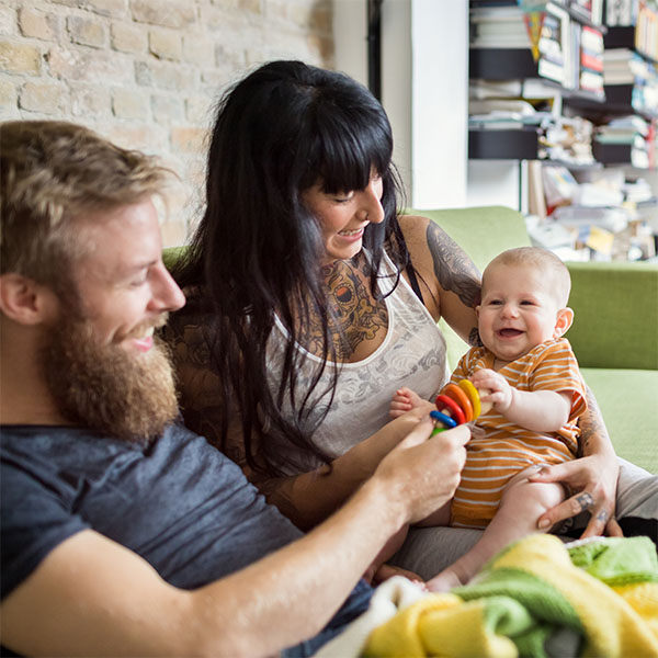 Couple on couch holding baby