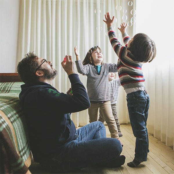 Dad and kids blowing bubbles